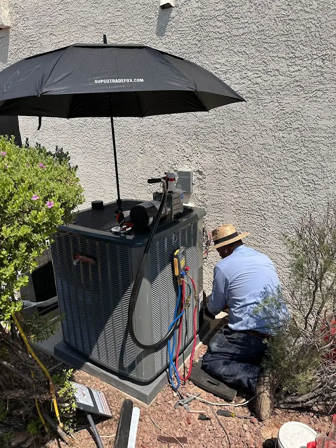 HVAC technician performing outdoor AC maintenance in Shepherdsville