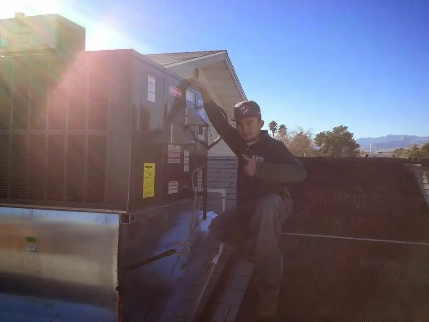 HVAC technician performing HVAC Inspection on a rooftop unit in Shepherdsville
